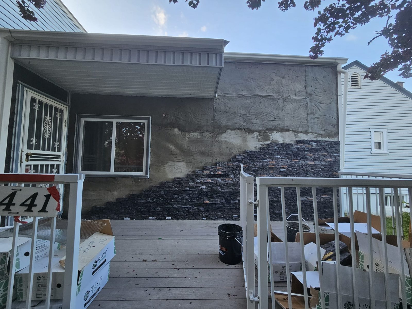 Stone veneer being installed on Calgary home exterior