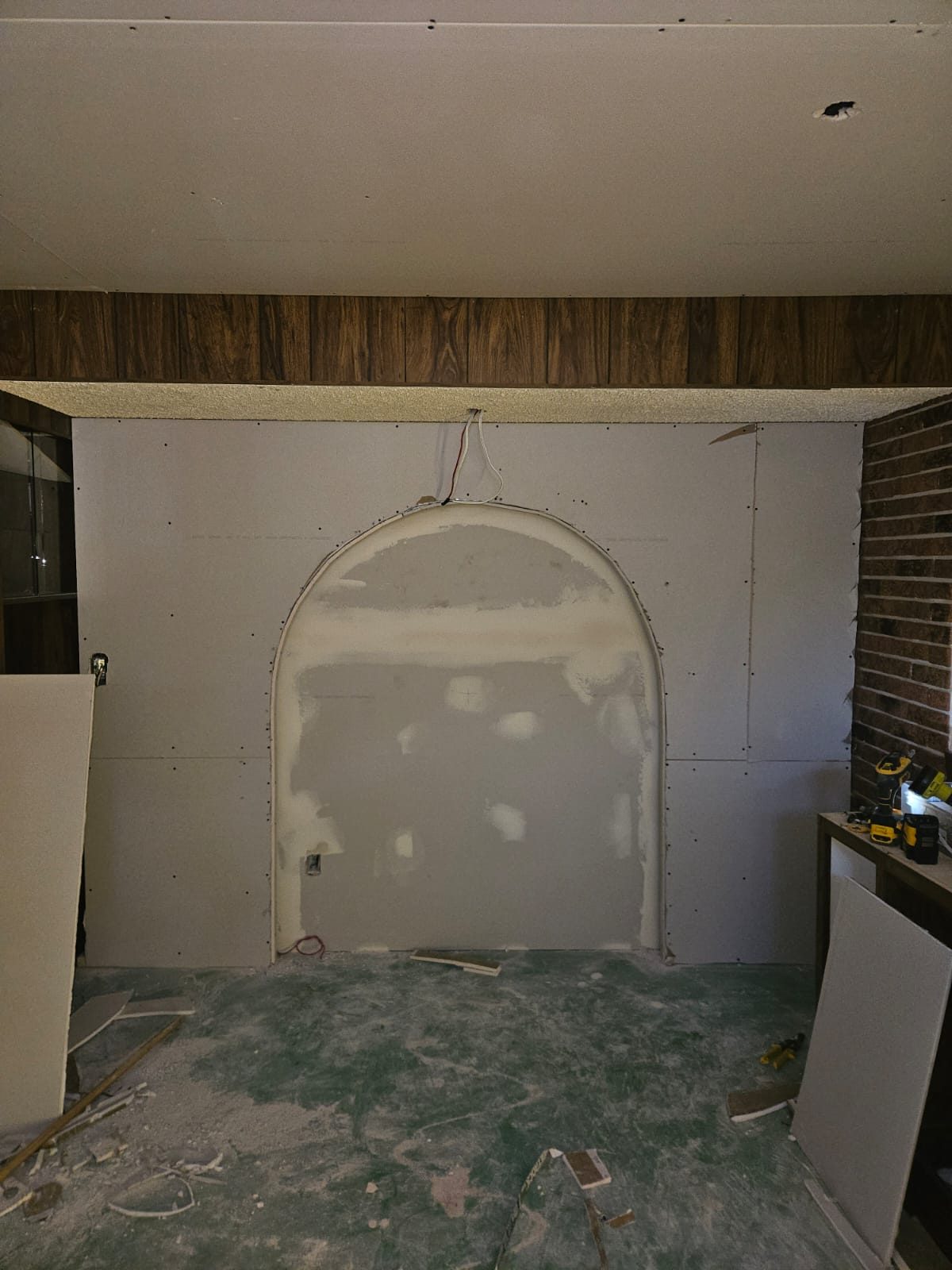 Arched feature wall before renovation, bare drywall