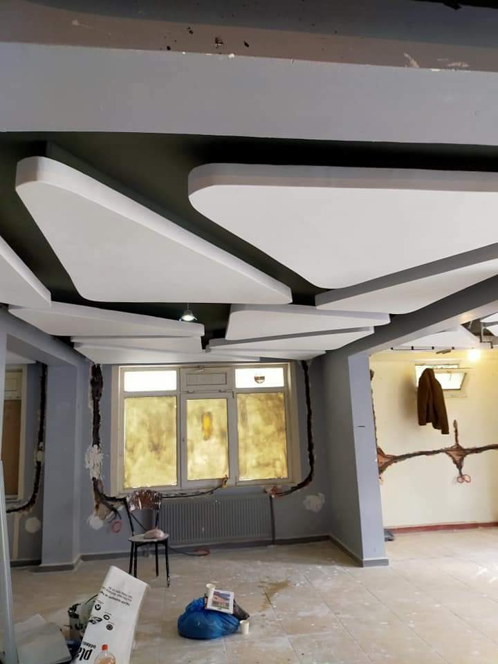 Living room with geometric ceiling after renovation in Calgary