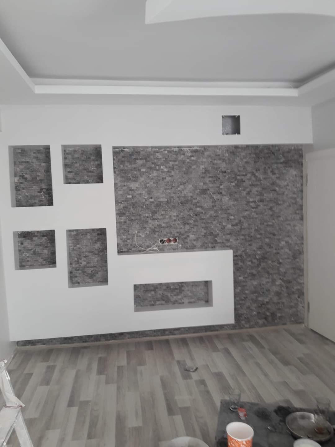 TV feature wall with stone veneer and display niches, Calgary