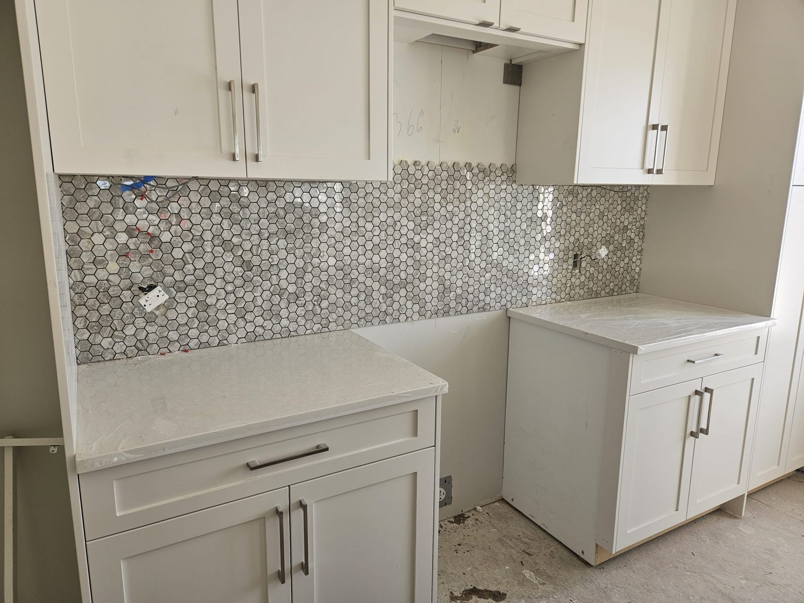 Bright white kitchen with marble-look backsplash, Calgary renovation