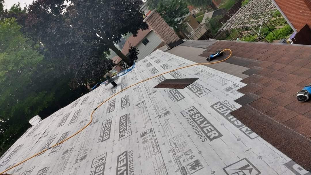 Roof underlayment being installed before shingles